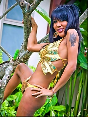 Pretty t-girl showing off and playing with a kinky green toy